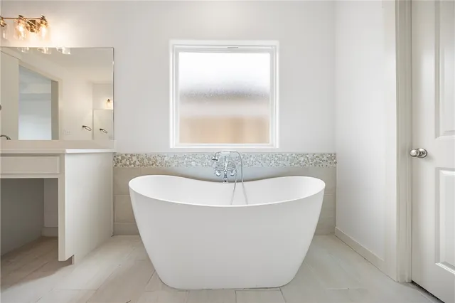 a white bath tub sitting in a bathroom