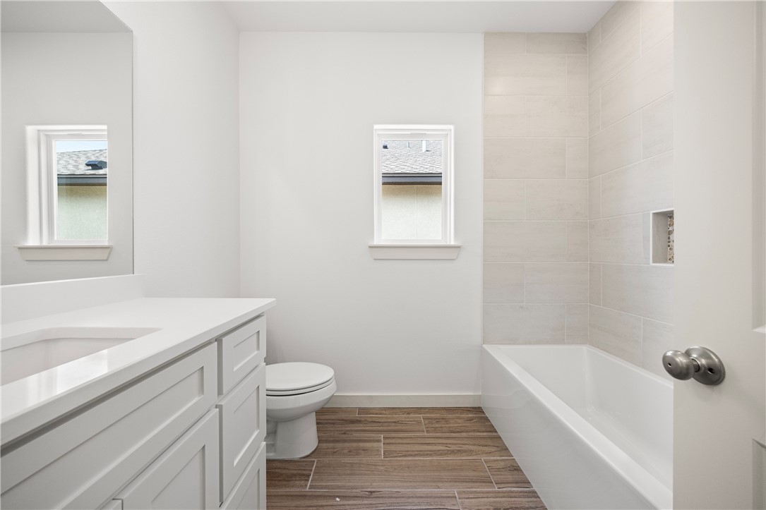 1702 Elm View Drive Corpus Christi, TX 78418 - Photo 22 of 27 a bathroom with a sink a toilet and shower