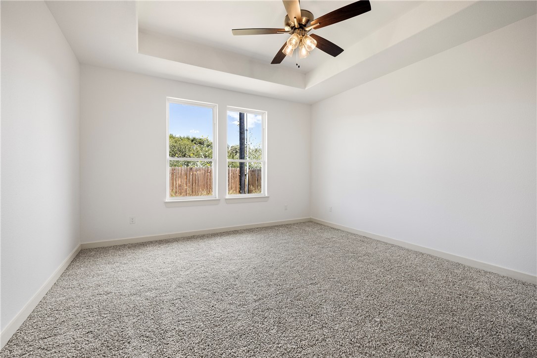1702 Elm View Drive Corpus Christi, TX 78418 - Photo 10 of 27 an empty room with windows and fan