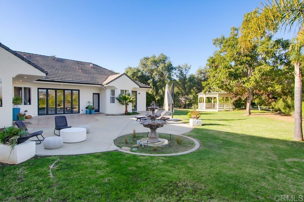 2241 Via Corto Fallbrook, CA 92028 - Photo 51 of 66 a view of a house with swimming pool and a garden