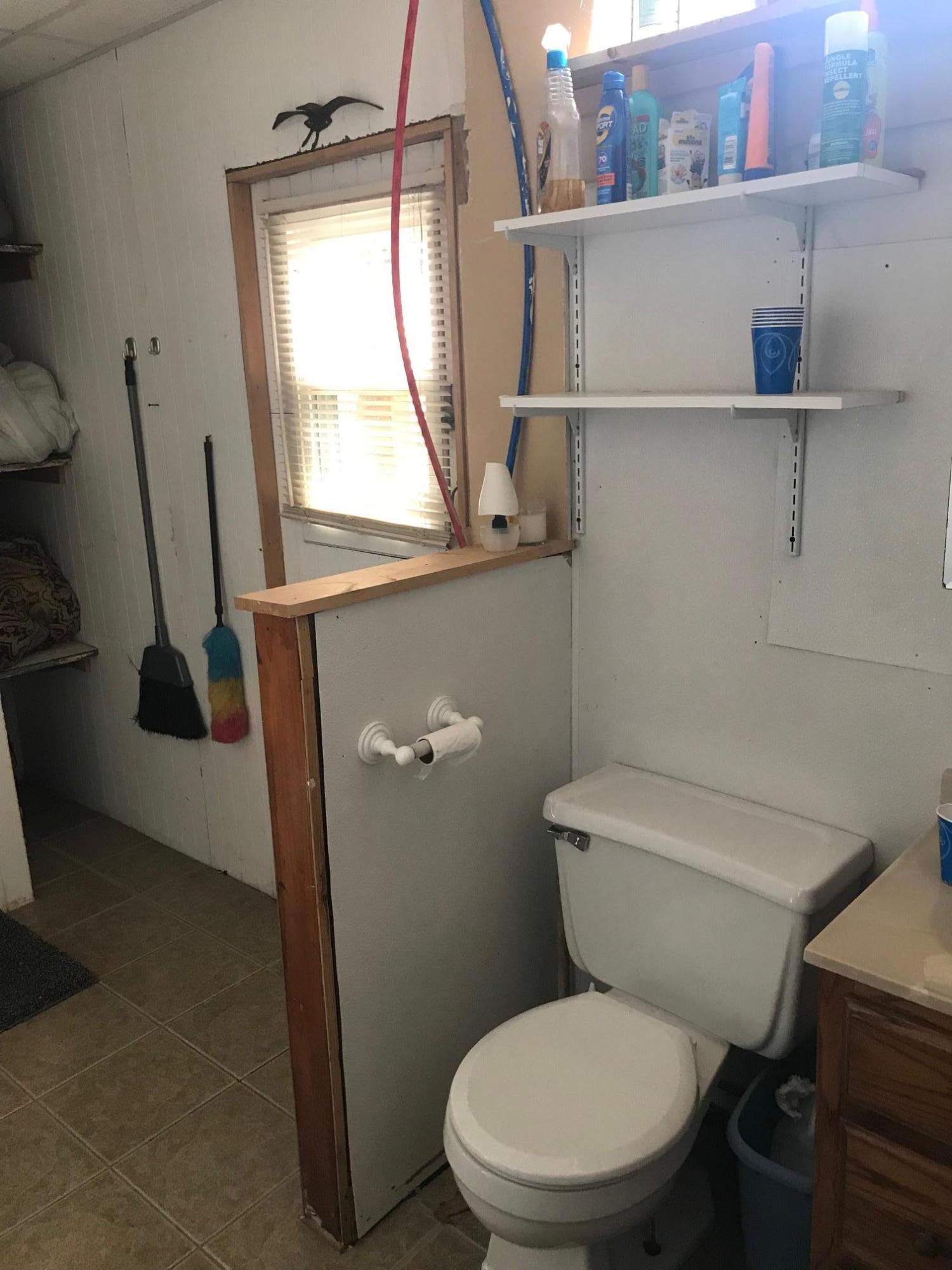 262 Old Wharf Road, Unit 67 Dennis Port, MA 02639 - Photo 15 of 28 a white toilet sitting next to a window