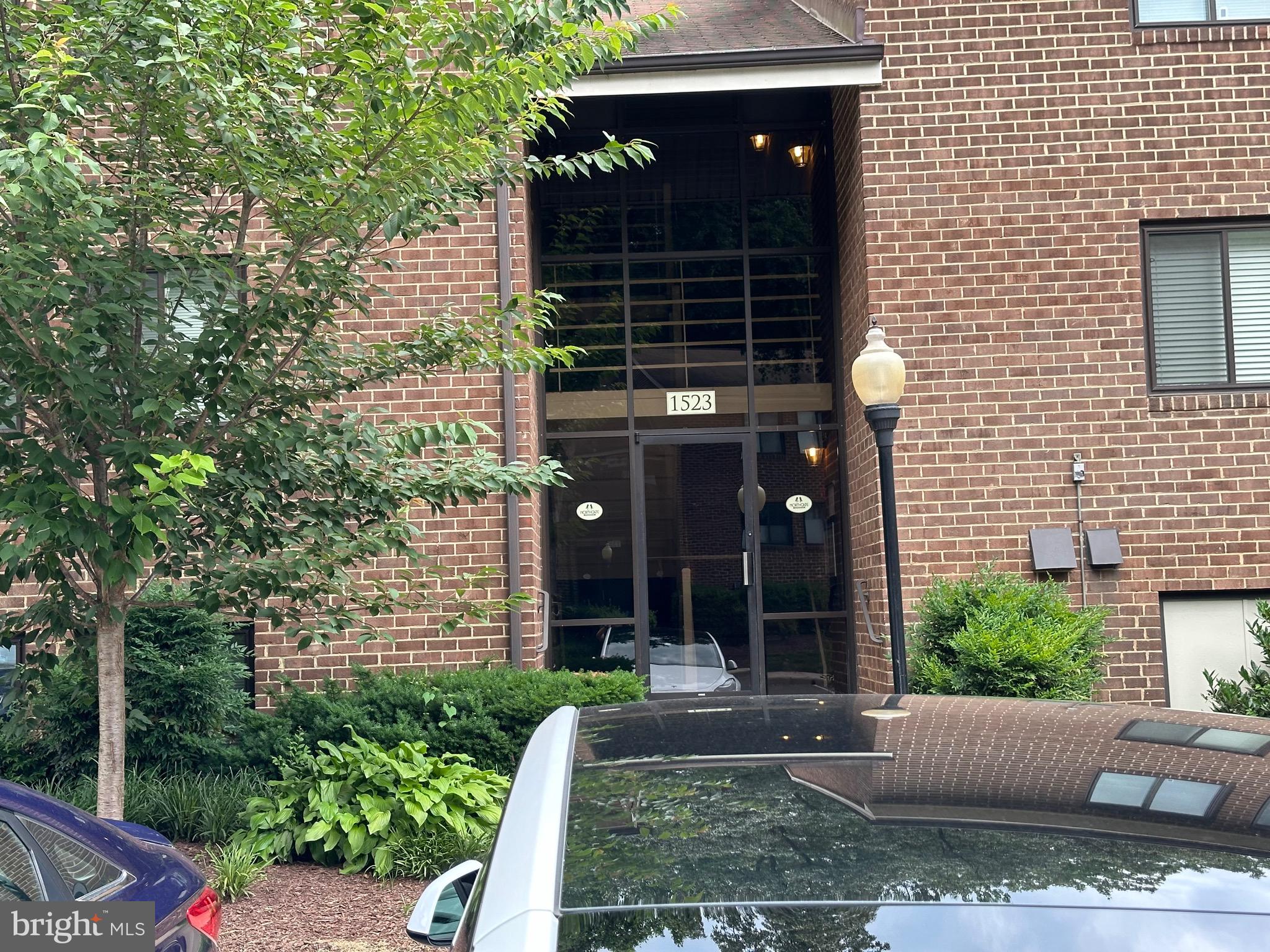 a view of a house with a yard and potted plants