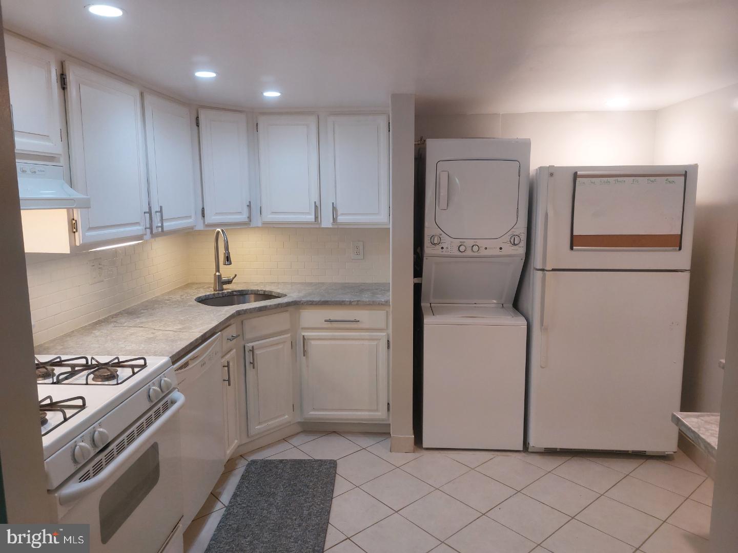 1523 Northgate Square, Unit 15231B Reston, VA 20190 - Photo 12 of 12 a kitchen with white cabinets and white appliances