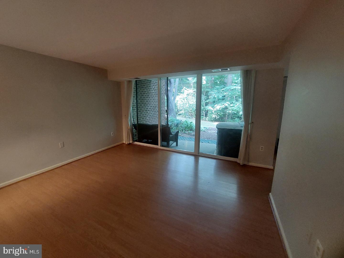 1523 Northgate Square, Unit 15231B Reston, VA 20190 - Photo 4 of 12 a view of a livingroom with wooden floor and a window