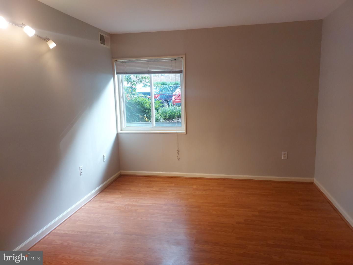 1523 Northgate Square, Unit 15231B Reston, VA 20190 - Photo 6 of 12 an empty room with wooden floor and windows