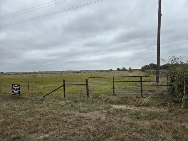 a view of a garden with wooden fence