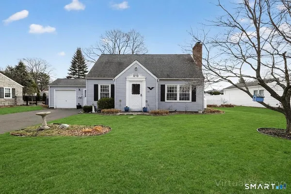 a front view of a house with a garden