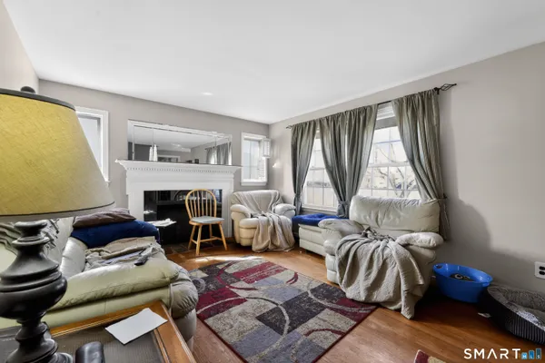 a living room with furniture a fireplace and a large window