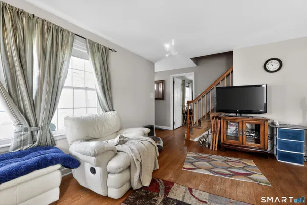 a living room with furniture and a flat screen tv