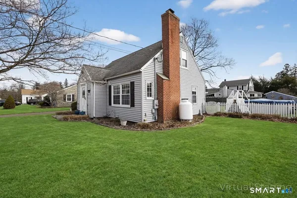a backyard of a house with table and chairs