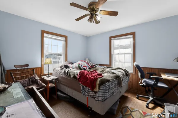 a bed sitting in a bedroom next to a window
