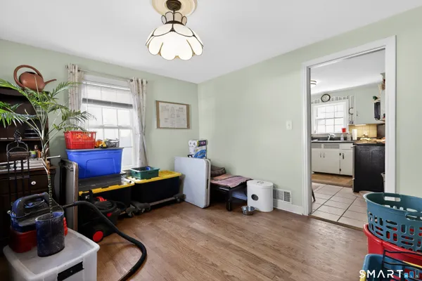 a bedroom with furniture and a wooden floor