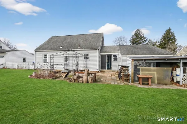 a view of a house with a yard and sitting area