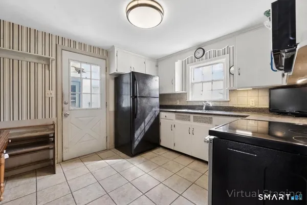 a kitchen with a refrigerator sink and cabinets