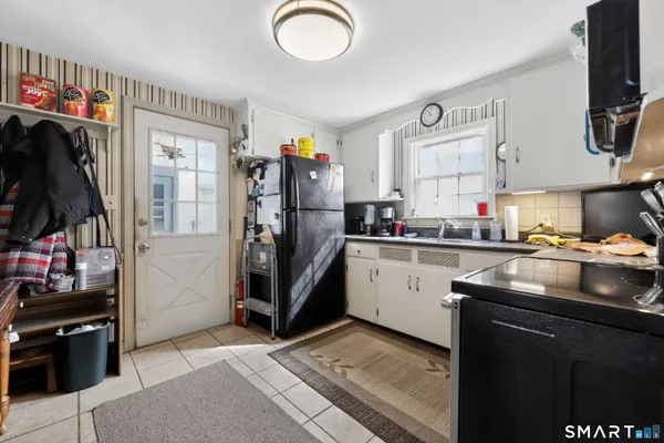 a kitchen with a sink cabinets and appliances