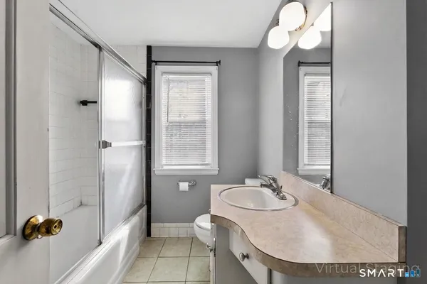 a bathroom with a sink mirror vanity and a toilet