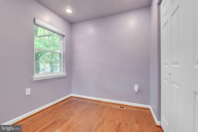 a view of room with window and hardwood floor