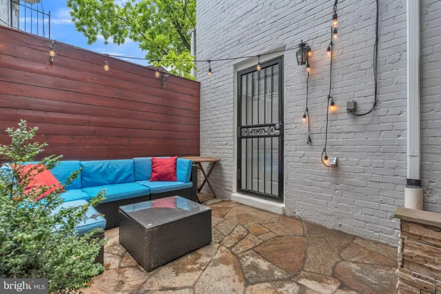 a backyard of a house with outdoor seating