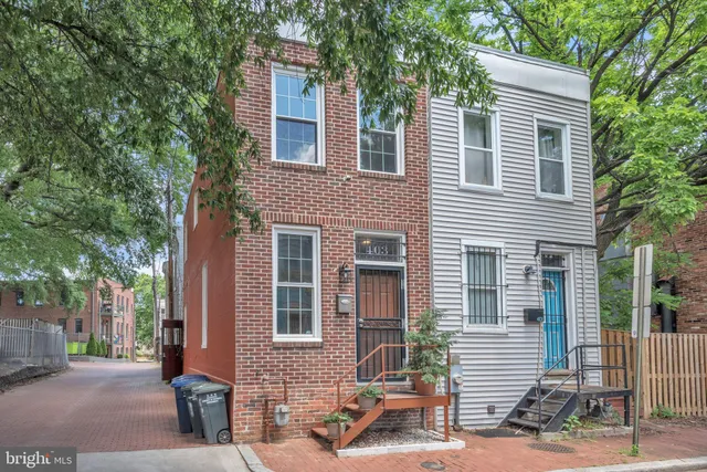 a front view of a house with a tree