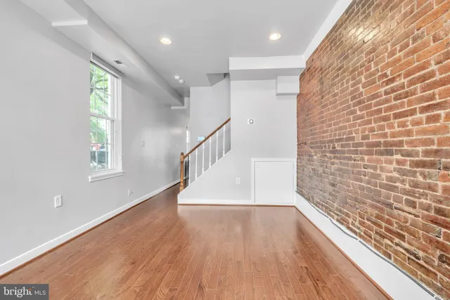a view of hallway with stairs and wooden floor