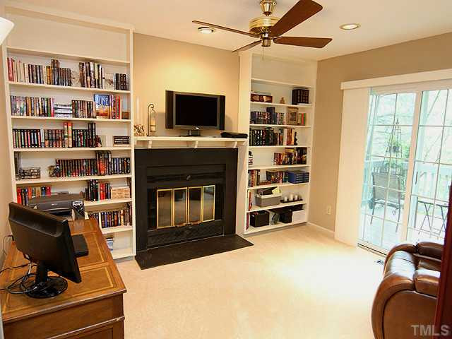 22 Sandstone Ridge Drive Durham, NC 27713 - Photo 8 of 16 a living room with a bookshelf and a flat screen tv