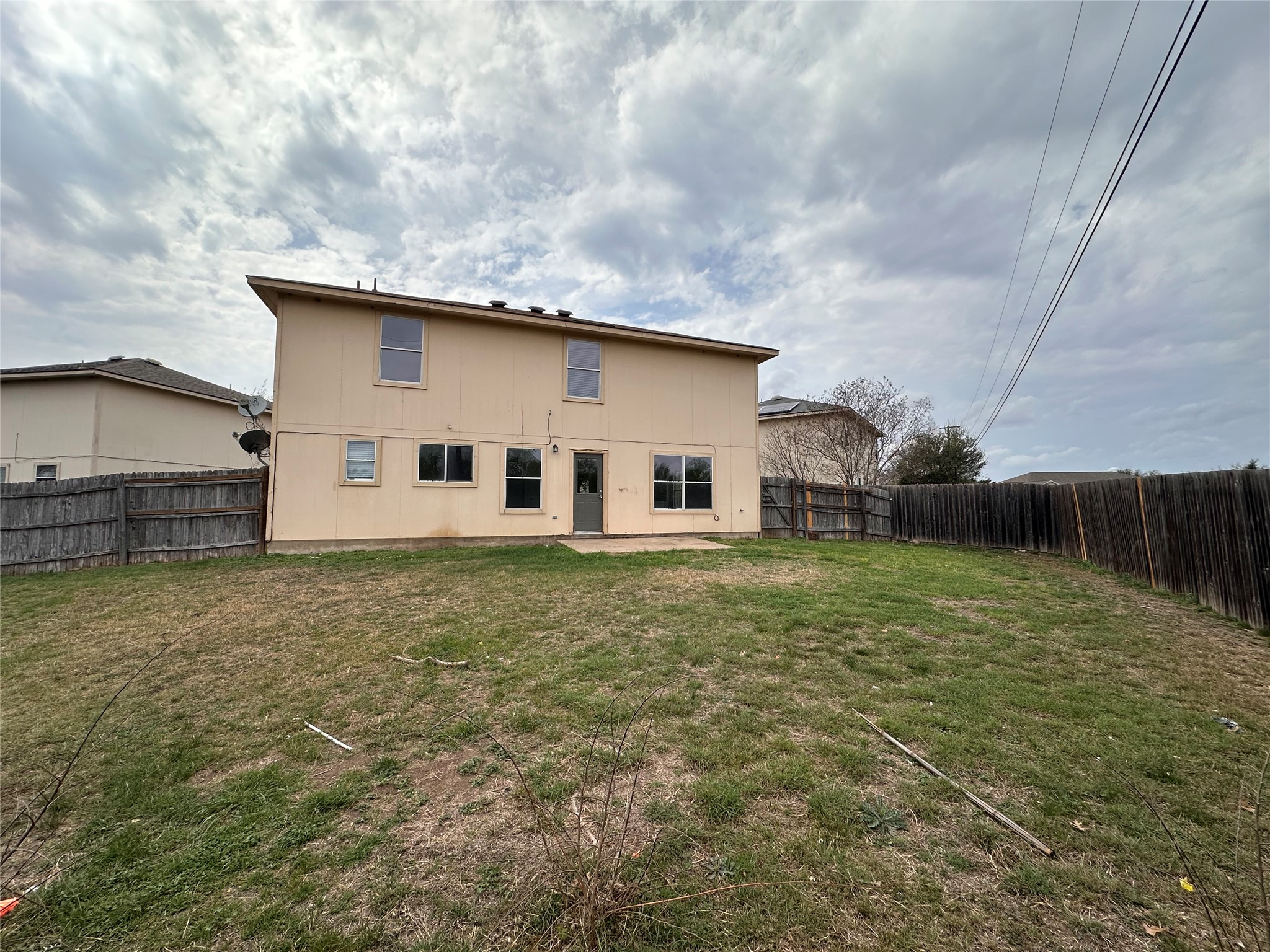 722 Lavaca Loop Elgin, TX 78621 - Photo 24 of 24 Rear view of house with a patio and a fenced backyard
