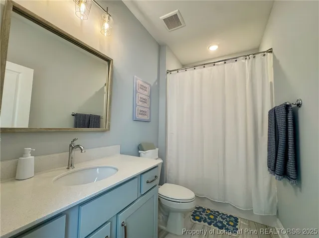 a spacious bedroom with a bed and a couch