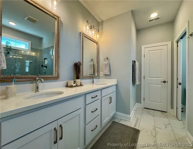 a bedroom with a bed a table and a chandelier