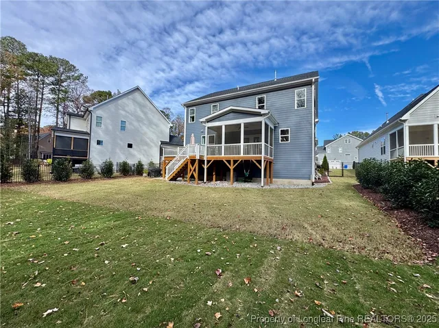 a view of a house with yard and sitting area