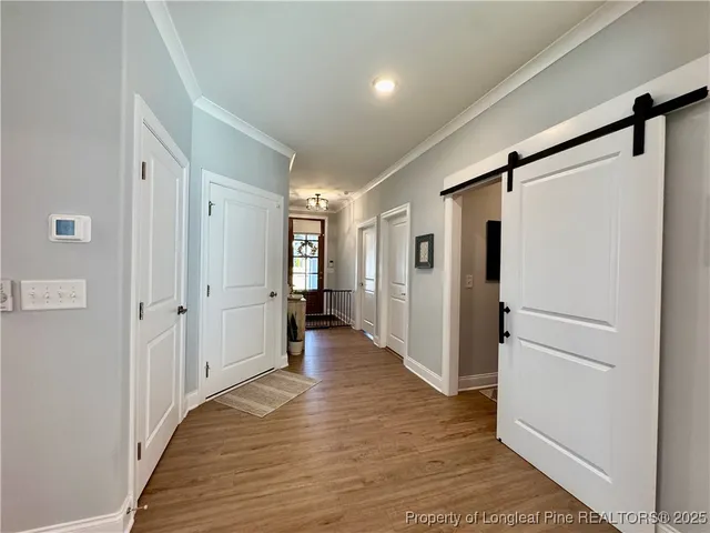 a kitchen with a dining table chairs refrigerator and microwave