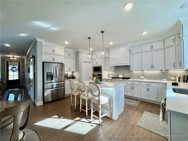 a living room with furniture a wooden floor and a fireplace