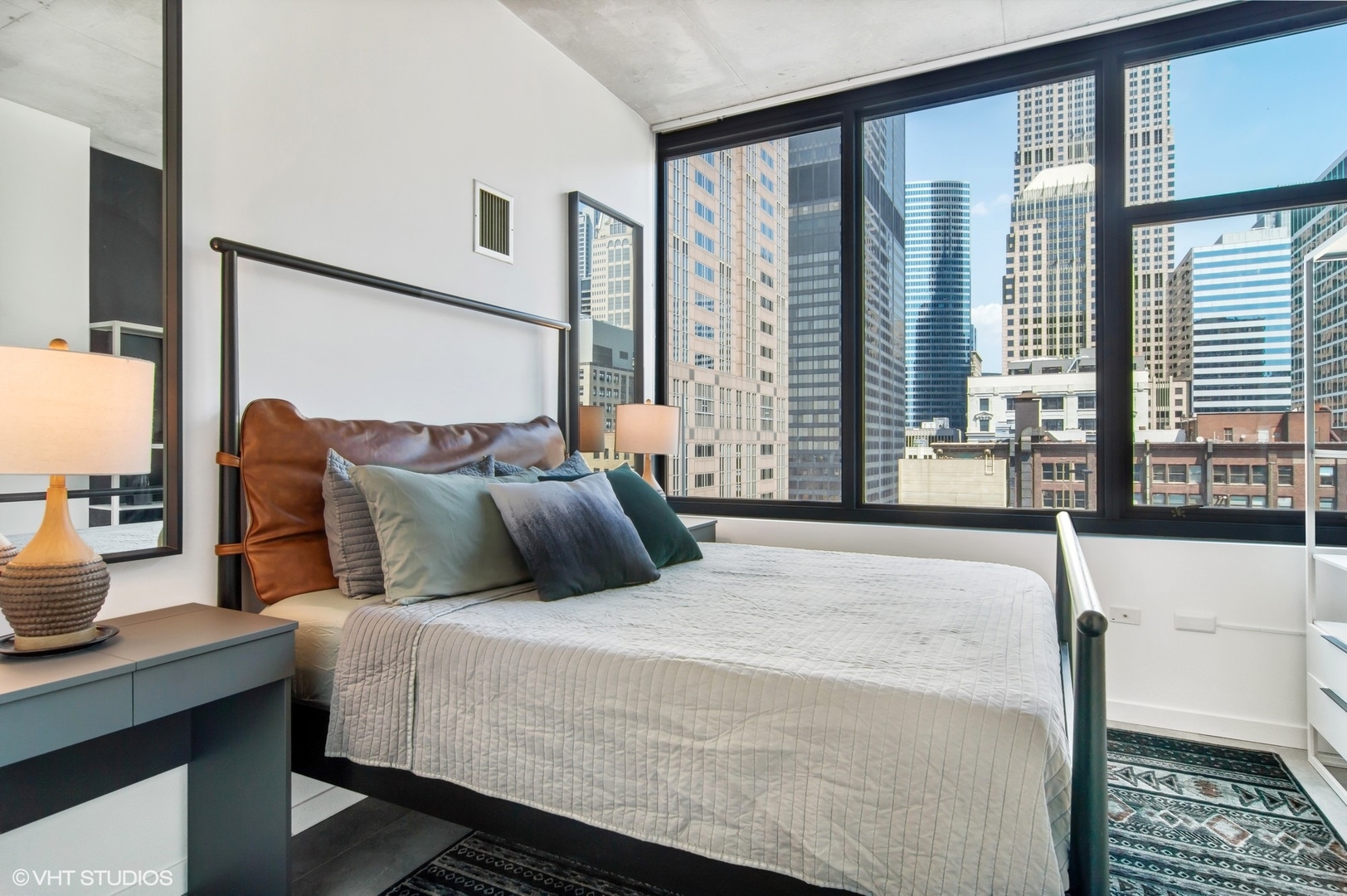 235 West Van Buren Street, Unit 1815 Chicago, IL 60607 - Photo 6 of 17 a bedroom with a large bed and a window