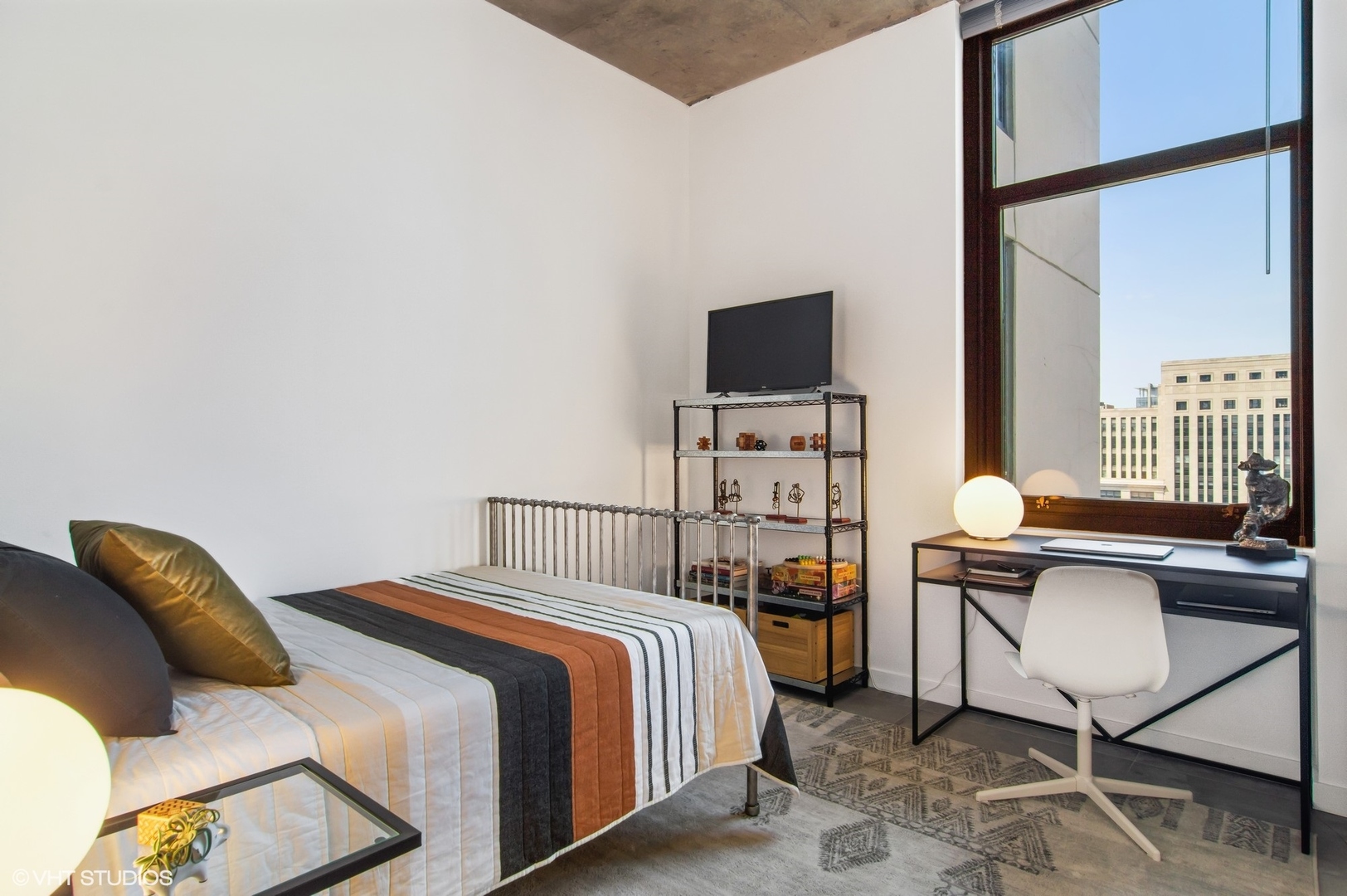 235 West Van Buren Street, Unit 1815 Chicago, IL 60607 - Photo 9 of 17 a bedroom with a bed and a flat screen tv
