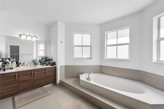 a spacious bedroom with a bed and a flat screen tv