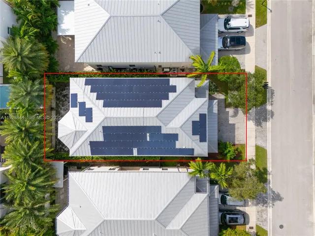 a view of a white house with a yard and plants