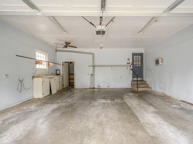 660 Hinton Road Counce, TN 38326 - Photo 2 of 40 Spacious garage featuring a concrete floor, built-in cabinetry, a window, and an interior access door with steps