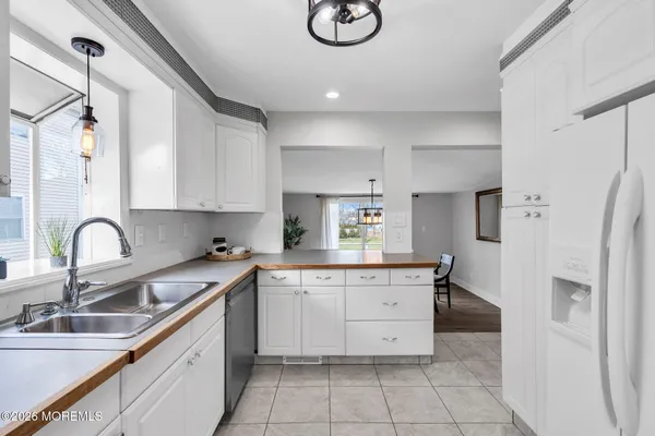 a kitchen with a sink cabinets and refrigerator