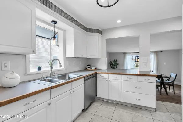 a kitchen with cabinets appliances and a sink