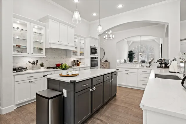 a kitchen with a sink stove and cabinets