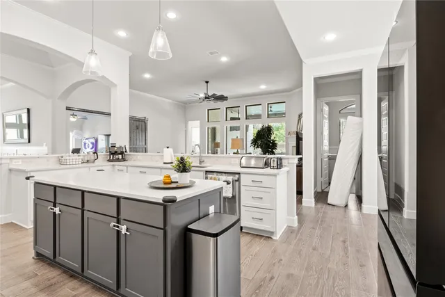 a kitchen with sink stove and refrigerator