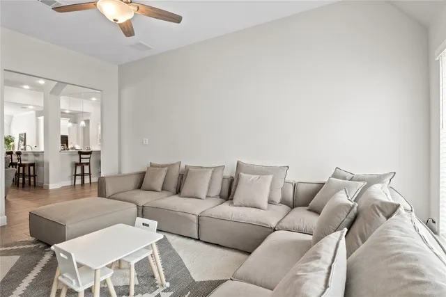 a living room with furniture and view of kitchen