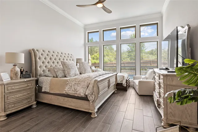 a spacious bedroom with a bed and a large window