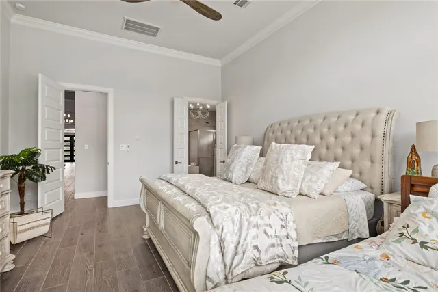 a bedroom with a bed and a potted plant