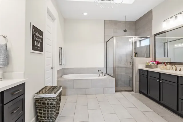a bathroom with a tub sink and a mirror
