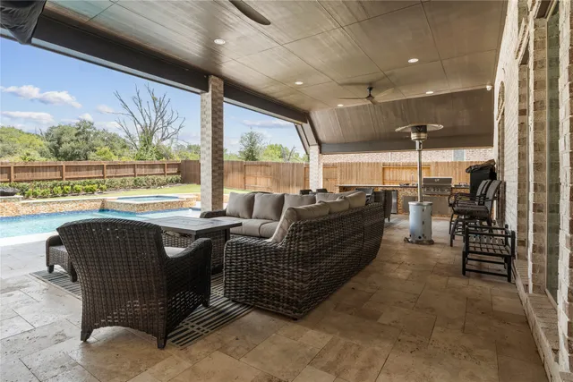 a living room with furniture a floor to ceiling window and a table