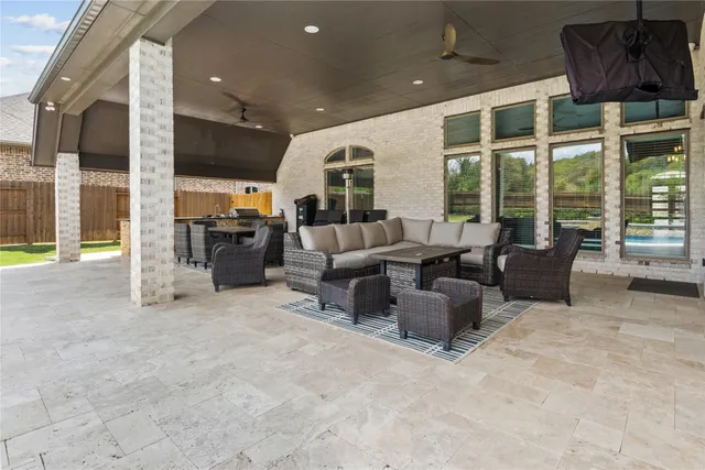 a living room with furniture and large windows