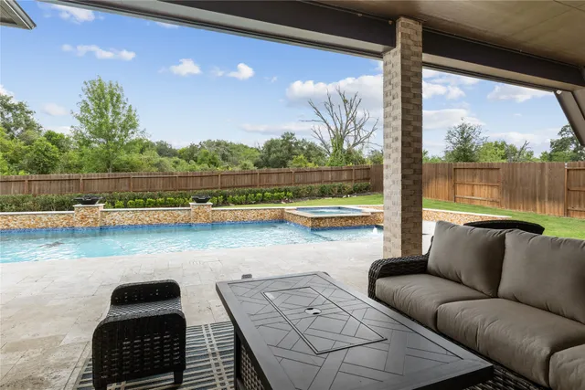 a balcony with furniture and a floor to ceiling window