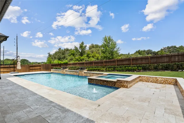 a view of swimming pool with a back yard