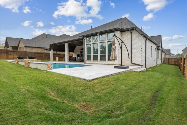 a view of a house with a yard and sitting area