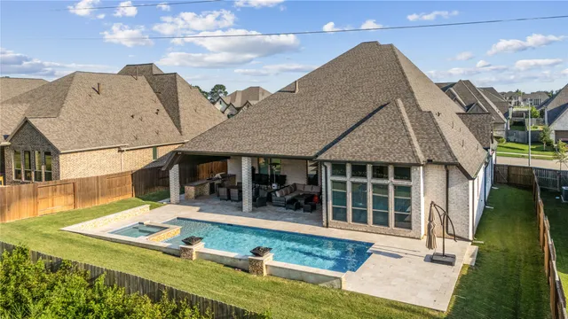 a view of a house with floor to ceiling windows and a rug